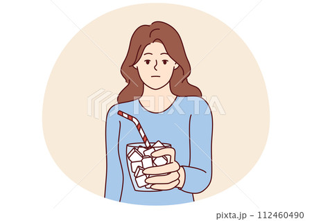 Emotionless girl holds glass full of sugar with straw symbolizing unhealthy nutrition Emotionless girl holds glass full of sugar with straw symbolizing unhealthy nutrition 112460490