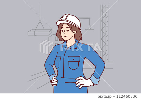 Woman builder stands on construction site near multi-story buildings and tower cranes lifting slabs 112460530