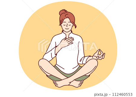 Woman meditates with hand on heart and wishes to heal herself through yoga and spiritual practice 112460553