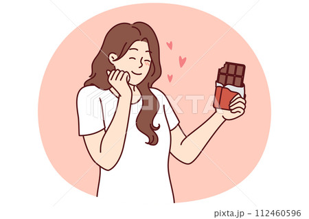 Happy woman enjoying taste of dark chocolate using sweet dessert for snacking and removing hunger 112460596