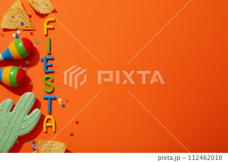 The inscription Fiesta with decorations on an orange background 112462010