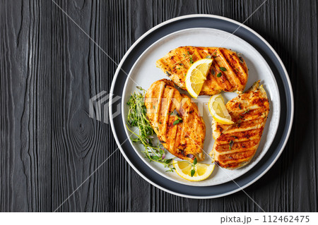 juicy grilled chicken cutlets on plate, top view juicy grilled chicken cutlets on plate, top view 112462475