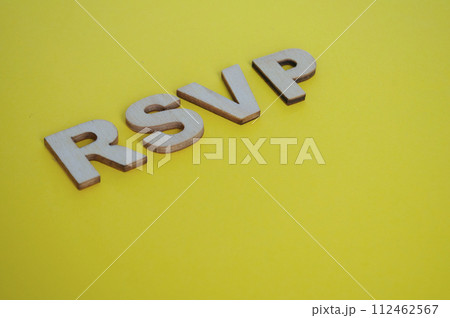 RSVP wooden letters representing Please respond on yellow background RSVP wooden letters representing Please respond on yellow background 112462567