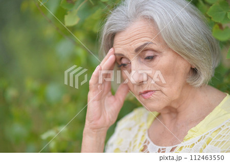 Portrait of sad seniour woman in park Portrait of sad seniour woman in park 112463550