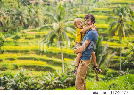 Dad and son travelers on Beautiful Rice Terraces against the background of famous volcanoes in Bali, Indonesia Traveling with children concept 112464773
