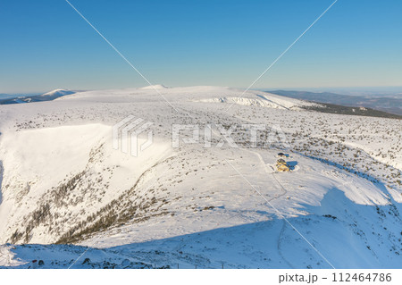 Winter morning,  view from Snezka to Silesian house, krkonose mountains. Snezka is mountain on the border between Czech Republic and Poland. 112464786