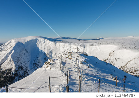Winter morning , steel railing tube with a chain on danger path from Silesian house to Snezka, mountain on the border between Czech Republic and Poland. 112464787