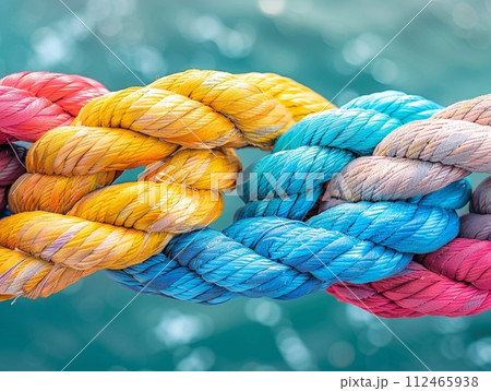 Blue and yellow rope intertwined with texture, isolated on white background 112465938