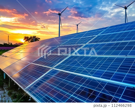 Solar energy technology featuring panels and turbines, installed on rooftops under a blue sky 112466298
