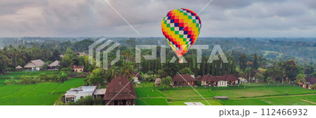 hot air balloon over the green paddy field. Composition of nature and blue sky background. Travel concept BANNER, LONG FORMAT hot air balloon over the green paddy field. Composition of nature and blue sky background. Travel concept BANNER, LONG FORMAT 112466932