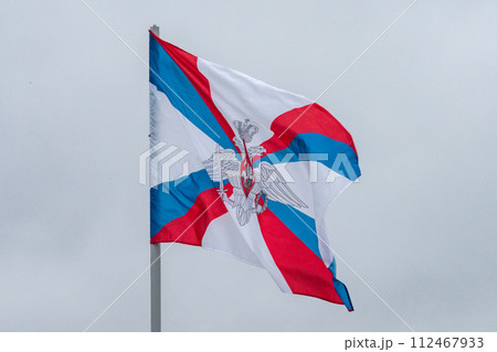 The flag of the Ministry of Defense of the Russian Federation is flying in the wind against a cloudy sky. 112467933