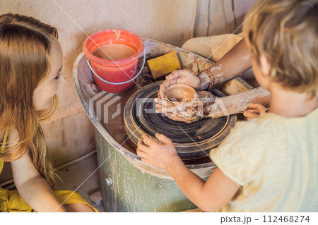 mother and son doing ceramic pot in pottery workshop mother and son doing ceramic pot in pottery workshop 112468274