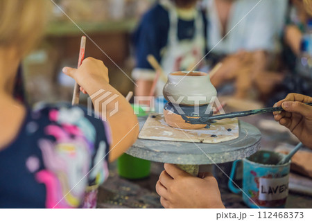 mother and son doing ceramic pot in pottery workshop mother and son doing ceramic pot in pottery workshop 112468373