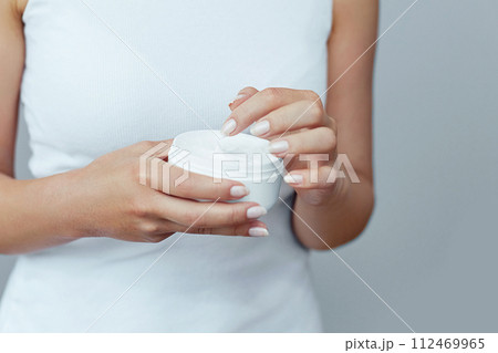 Hand Skin Care. Close Up Of Female Hands Holding Cream Tube, Woman Hands With Natural Manicure Nails Applying Cosmetic Hand Cream On Soft Silky Healthy Skin. Beauty And Body Care Concept Hand Skin Care. Close Up Of Female Hands Holding Cream Tube, Woman Hands With Natural Manicure Nails Applying Cosmetic Hand Cream On Soft Silky Healthy Skin. Beauty And Body Care Concept 112469965
