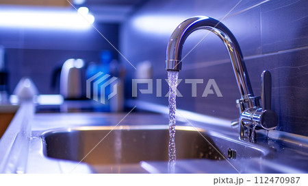 Faucet with running water, kitchen background, high tech style. Save the water concept. 112470987