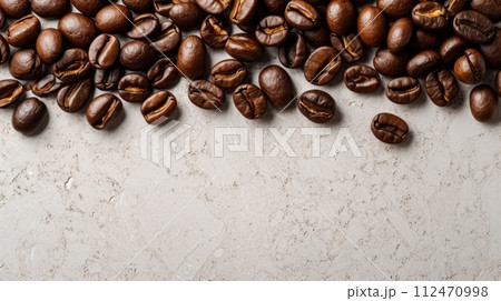 Pile of Freshly Roasted Dark Coffee Beans on a Clean White Surface Pile of Freshly Roasted Dark Coffee Beans on a Clean White Surface 112470998