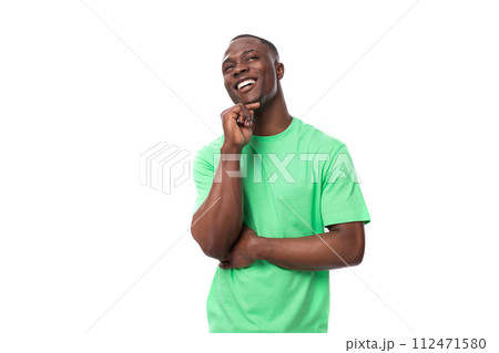 30 years old smart successful african man dressed in a light green t-shirt on an isolated white 30 years old smart successful african man dressed in a light green t-shirt on an isolated white 112471580