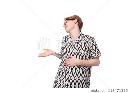 young handsome red-haired guy in glasses dressed in a summer shirt holds out his hand for a young handsome red-haired guy in glasses dressed in a summer shirt holds out his hand for a 112471586