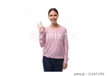 a young smiling European woman with black hair gathered in a ponytail is dressed in a red and white 112471793