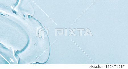 The smear of a transparent gel on a blue background. 112471915