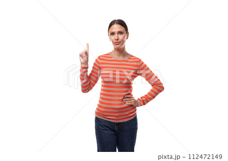 Young smart slim brunette woman dressed in a striped orange blouse and jeans on a white background 112472149