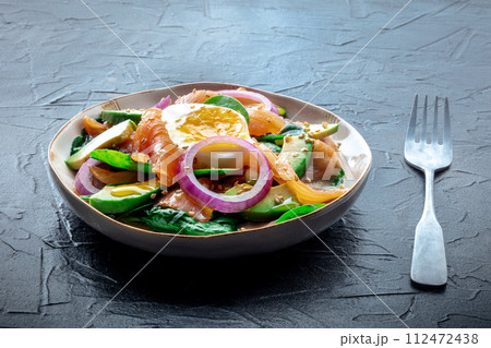 Salmon, avocado and egg salad with fresh leaves and onions Salmon, avocado and egg salad with fresh leaves and onions 112472438