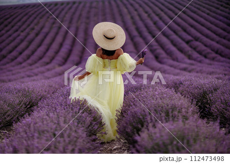 Woman lavender field. Lavender field happy woman in yellow dress in lavender field summer time. Aromatherapy concept, lavender oil, photo session in lavender 112473498