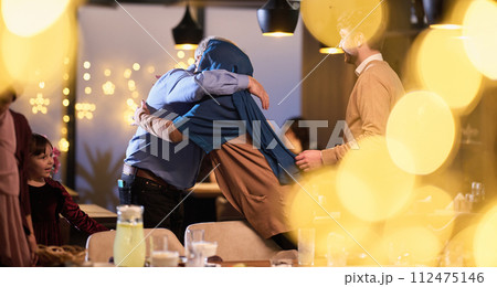 Grandparents arrive at their children's and grandchildren's gathering for iftar in a restaurant during the holy month of Ramadan, bearing gifts and sharing cherished moments of love, unity, and Grandparents arrive at their children's and grandchildren's gathering for iftar in a restaurant during the holy month of Ramadan, bearing gifts and sharing cherished moments of love, unity, and 112475146
