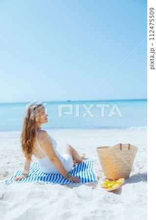 relaxed modern 40 years old woman on ocean shore relaxed modern 40 years old woman on ocean shore 112475509