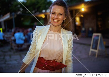 Portrait of happy woman in dress and jacket in city Portrait of happy woman in dress and jacket in city 112475907