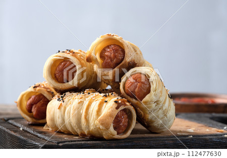 Homemade Sausage in dough rolls on plate 112477630