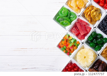 Group of dried and candied fruit in bowl 112477737