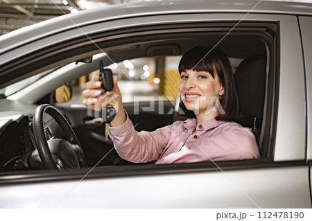 Caucasian woman in casual clothes sitting behind wheel of modern car. 112478190