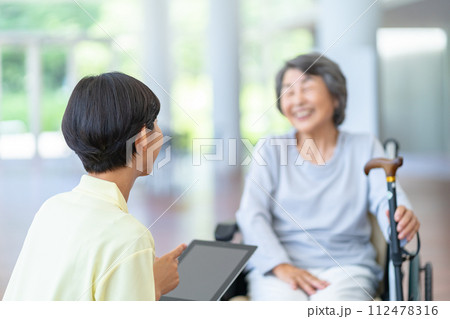 介護士とお婆さん　車いすに座ったシニア女性 112478316