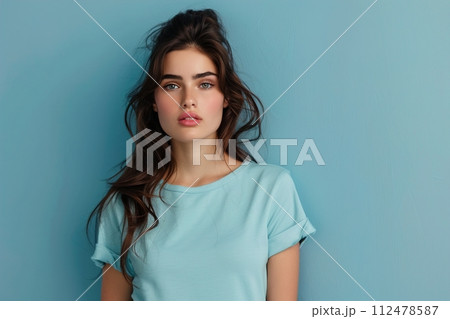 A woman with long brown hair is wearing a blue shirt 112478587