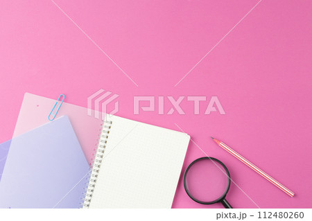 Spiral notepad with stationery on the desk. 112480260
