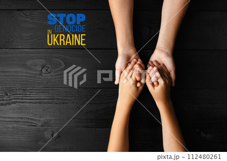 childrens hands holding each other dark background childrens hands holding each other dark background 112480261