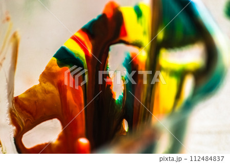 Colorful paint in a glass, close-up, macro. Colorful paint in a glass, close-up, macro. 112484837