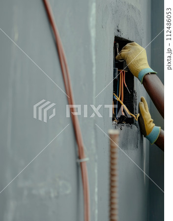Electrician man worker checking electric box in a office room . Generative AI 112486053