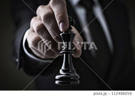 Businessman holding chess piece in competition, business success concept. Generative AI. 112486059