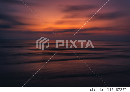Sunset on the beach Beautiful colors of the sky and sea 112487272