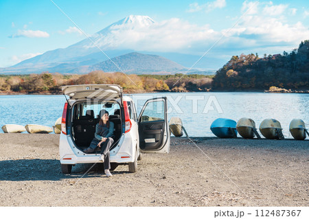 Woman tourist enjoy with Fuji Mountain at Lake Shoji, happy Traveler sightseeing Mount Fuji and road trip Fuji Five Lakes. Landmark for tourists attraction. Japan Travel, Destination and Vacation 112487367