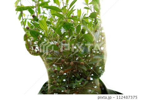 A double exposure portrait of a male portrait's silhouette on white background 112487375