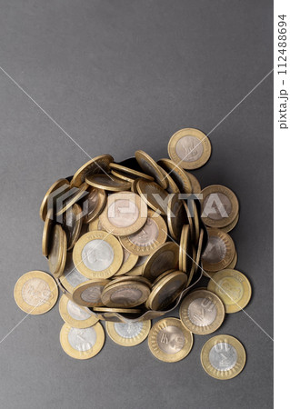 Pile of Indian ten rupee coins on gray background 112488694