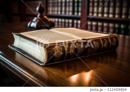An open book sitting on top of a wooden table 112489804