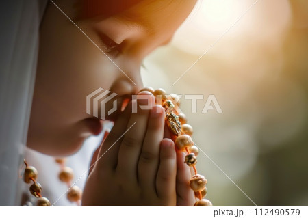 First communion joy: heartwarming moments of young believers in white dresses, celebrating this sacred Christian sacrament with faith, purity, spirit of spiritual growth in memorable church ceremony. 112490579