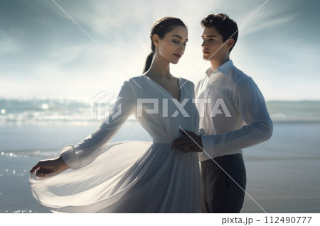 Capturing love on the beach: a beautiful couple shares intimate moments by the sea, surrounded by seagulls, enjoying the serenity, romance, and breathtaking scenery of their coastal paradise getaway. 112490777