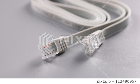 Closeup of rj45 cable on gray background Closeup of rj45 cable on gray background 112490957