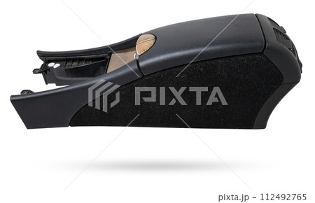 Plastic element of car interior is covered in black leather - armrest or a glove compartment - spare part with air conditioning holes on a white background. Catalog for site. 112492765
