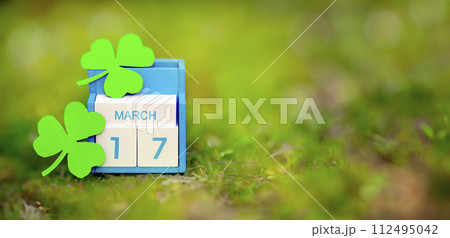 Save the date white block calendar for St Patrick's Day, March 17 on green background. 112495042